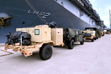 US Navy 110925-N-KM175-017 Vehicles and support gear assigned to the 31st MEU line the pier at White Beach Naval Facility Okinawa to be loaded aboa