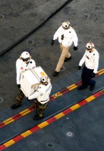 US Navy 110925-N-SF704-056 Hospital corpsmen aboard the aircraft carrier USS George Washington (CVN 73) carry a box of influenza vaccine aboard the