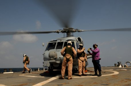 US Navy 110925-N-XQ375-047 Gas Turbine System Technician (Mechanical) 2nd Class Carrington Jones, right, shows a sample of JP-5 fuel to an MH-60R S