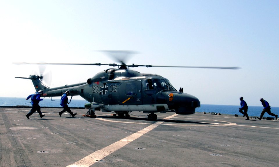 US Navy 110922-N-GH121-107 Sailors unchain a German marine Lynx helicopter as it prepares to depart after a refueling aboard the amphibious dock la