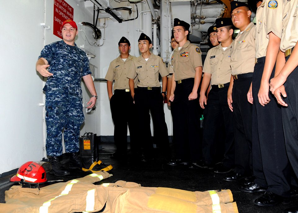 US Navy 110923-N-UE250-106 Damage Controlman 3rd Class Daniel Charlton, left, shows Navy Junior ROTC cadets from Father Duenas Memorial School the