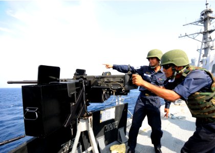 US Navy 110922-N-KK935-952 Bangladesh navy sailors riding the guided-missile destroyer USS Kidd (DDG 100) scope out a practice target before a live