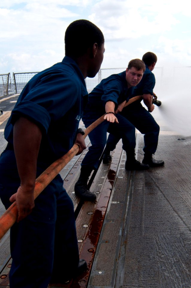 US Navy 110923-N-EA192-047 Sailors aboard the guided-missile destroyer USS Mustin (DDG 89) practice hose handling on the flight deck