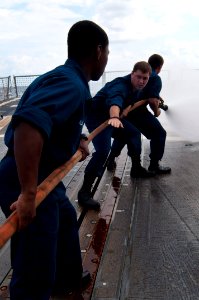 US Navy 110923-N-EA192-047 Sailors aboard the guided-missile destroyer USS Mustin (DDG 89) practice hose handling on the flight deck