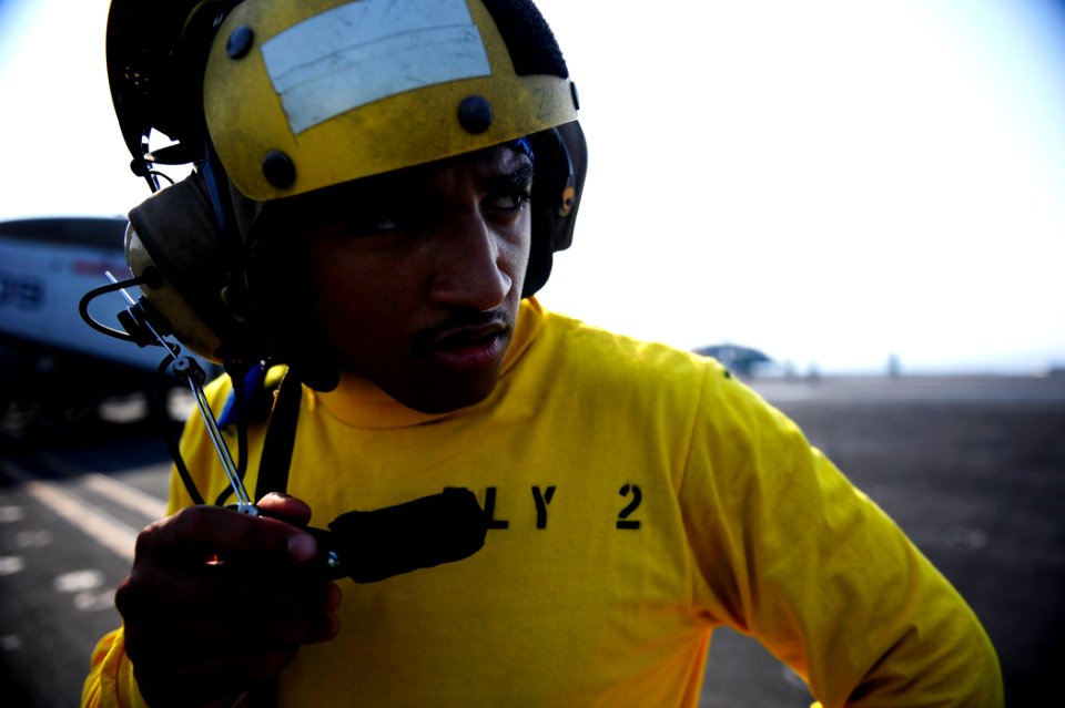 US Navy 110925-N-VN693-021 Aviation Boatswain's Mate (Handling) Airman Apprentice Terrance Wever, from Charleston, S.C., uses the microphone