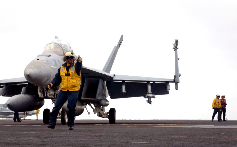 US Navy 110923-N-TZ605-452 Aviation Boatswain's Mate (Handling) 3rd Class Tamara Sewell, assigned to Air Department's V-1 Division, directs an F-A
