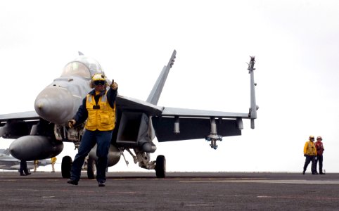 US Navy 110923-N-TZ605-452 Aviation Boatswain's Mate (Handling) 3rd Class Tamara Sewell, assigned to Air Department's V-1 Division, directs an F-A