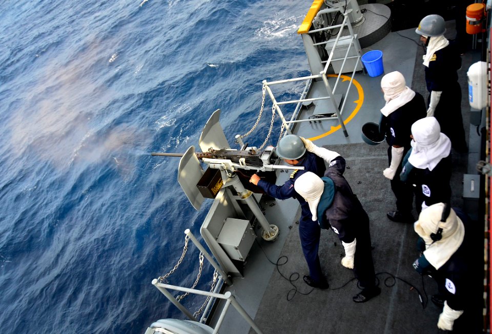 US Navy 110922-N-RI844-200 Capt. Abdullah Al Mamun, commanding officer of the Bangladesh navy frigate BNS Bangabandhu (F 25), fires a 12.7 mm heavy