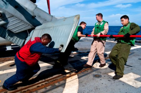 US Navy 110926-N-EA192-089 Sailors prepare a helicopter for flight operations