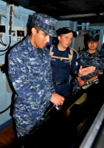 US Navy 110922-N-SF704-033 Seaman David Burton, from Albuquerque, N.M., right, trains Machinist's Mate Fireman Raymond Bones, from West Palm Beach