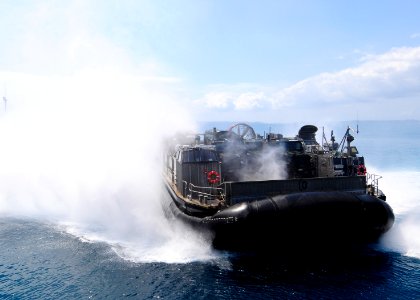 US Navy 110923-N-WJ771-163 A landing craft air cushion carrying equipment assigned to the 31st MEU approaches the well deck of USS Denver (LPD 9)