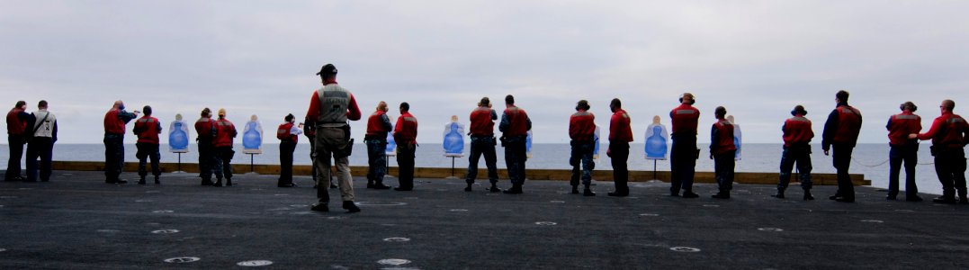 US Navy 110924-N-OK922-163 Sailors assigned to Weapons Department's G-2 Division participate in a 9mm pistol qualification aboard the Nimitz-class