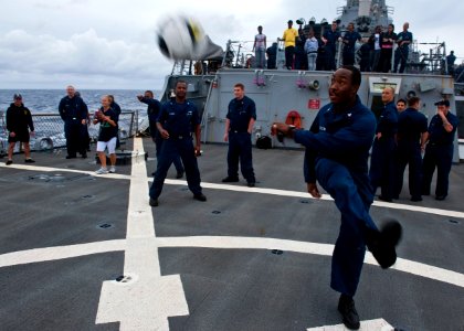 US Navy 110925-N-FI736-132 Interior Communications Electrician 3rd Class Rousseau Celestin kicks a soccer ball around during a steel beach picnic a