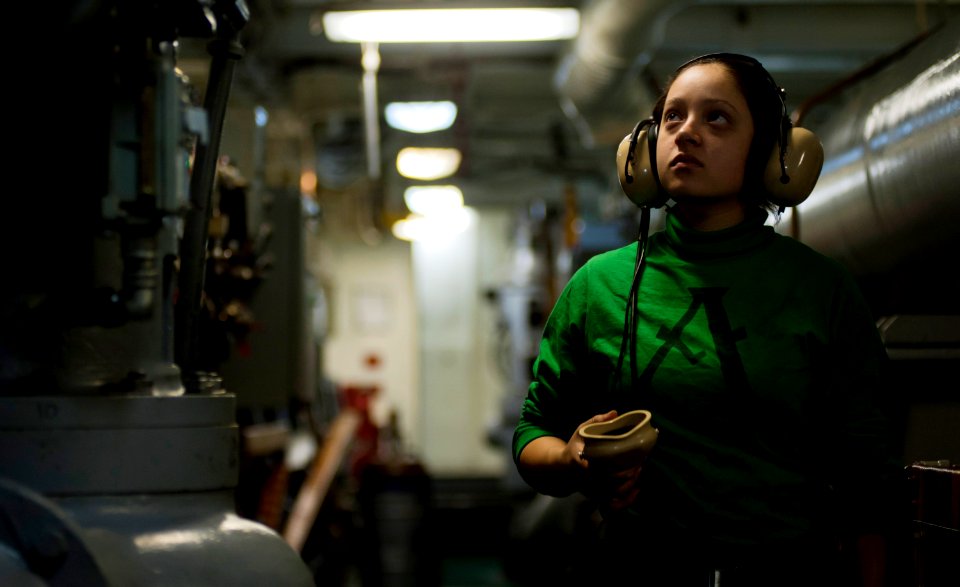 US Navy 110924-N-TU221-206 Aviation Boatswain's Mate (Equipment) Airman Gabrielle Dewitt makes rounds while standing watch inside an arresting gear