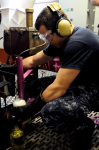 US Navy 110927-N-YC505-007 Aviation Boatswain's Mate (Fuel) Airman Cody L. Johnson takes a fuel sample to inspect for contaminants aboard the airc