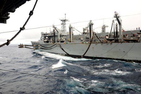 US Navy 110926-N-AU622-050 The Military Sealift Command fast combat support ship USNS Arctic (T-AOE 8) sends a fuel line to the aircraft carrier US