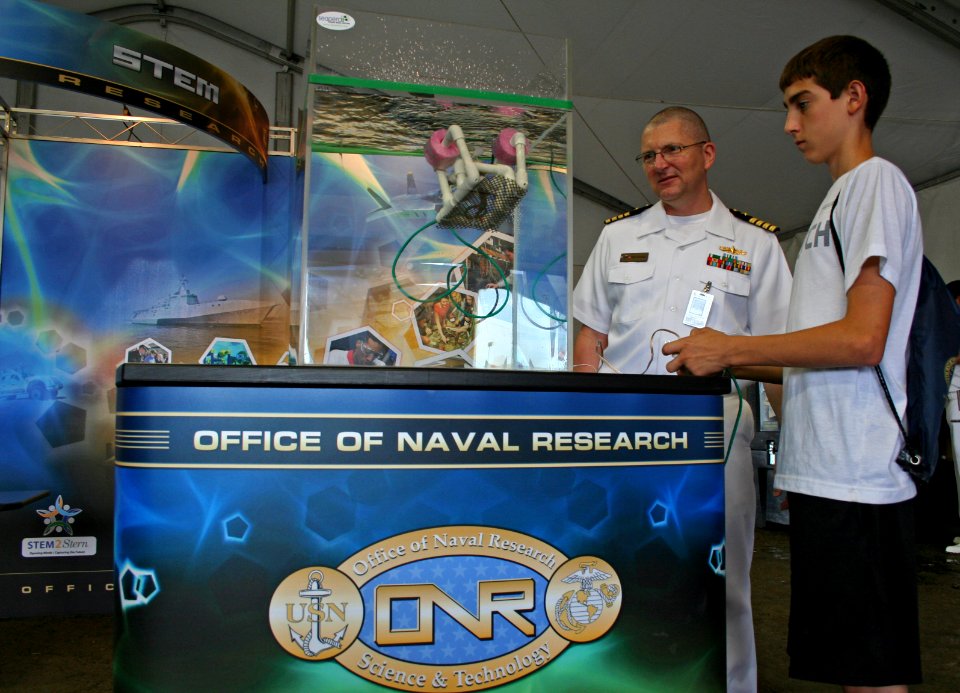 US Navy 110924-N-ZL585-205 Capt. Dan Burque, research liaison officer from the Office of Naval Research (ONR), helps a student operate an underwate