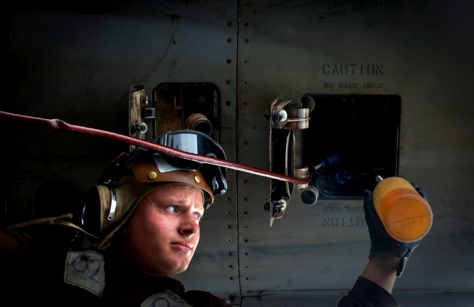 US Navy 110923-N-TZ605-335 A Sailor services an F-A-18C Hornet on the flight deck aboard the Nimitz-class aircraft carrier USS Carl Vinson (CVN 70)