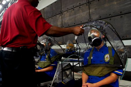US Navy 110927-N-ZC343-945 Sailors the amphibious assault ship USS Bonhomme Richard (LHD 6) are fitted for gas masks in the well deck of the ship