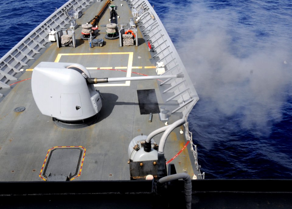 US Navy 110926-N-KB052-108 The Mk-45 5-inch .54-caliber gun is fired from the forecastle during a pre-action calibration live-fire exercise aboard