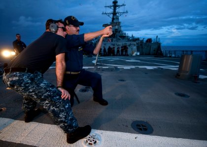 US Navy 110924-N-FI736-198 Sailors aboard the guided-missile destroyer USS Arleigh Burke (DDG 51) participate in a live-fire training exercise photo
