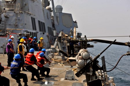 US Navy 110925-N-YZ751-008 Sailors aboard the guided-missile destroyer USS Truxtun (DDG 103) heave a line during a replenishment at sea photo