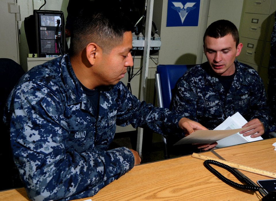 US Navy 110928-N-OK922-064 Personnel Specialist 3rd Class Luis Cano trains Personnel Specialist Seaman James Bryant on Leave and Earning Statement