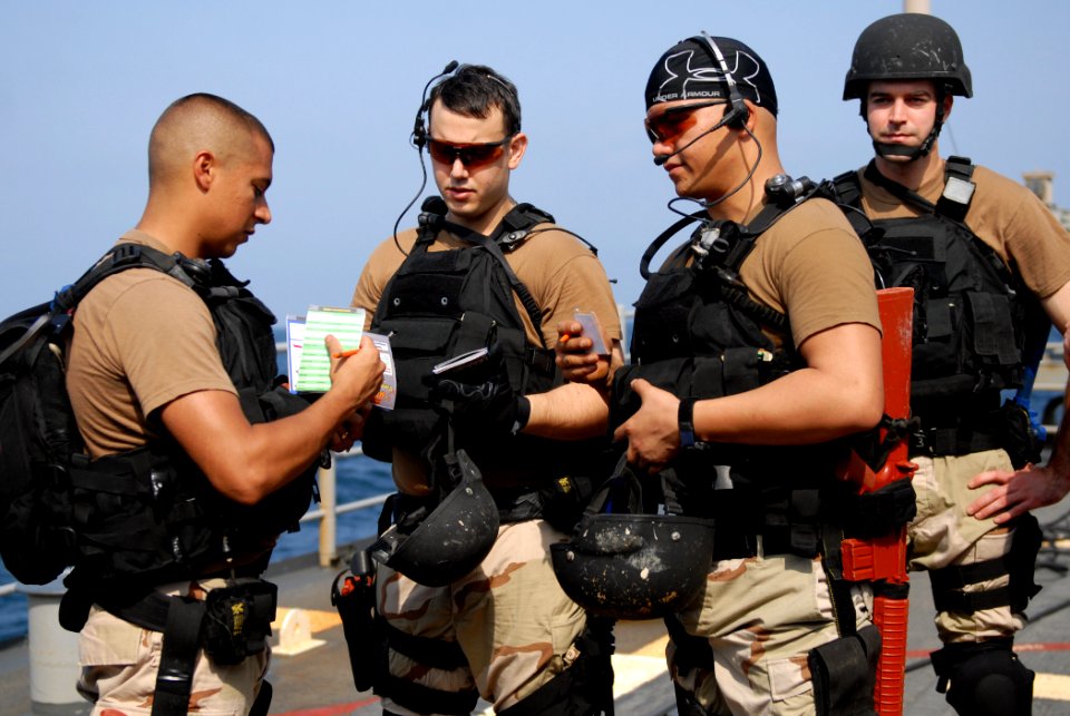 US Navy 110926-N-DU438-050 Members of the visit, board, search and seizure team discuss boarding techniques before a training exercise aboard