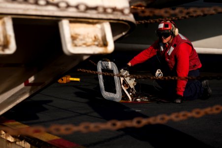 US Navy 110927-N-BT887-073 Aviation Ordnanceman Airman Gonzalo Mendez raises a weapons elevator on the flight deck of the Nimitz-class aircraft car