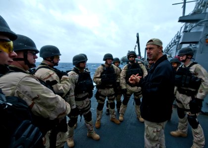 US Navy 110927-N-FI736-108 Lt. Cmdr. Kenneth Wasson briefs the visit, board, search and seizure (VBSS) team aboard the guided-missile destroyer USS
