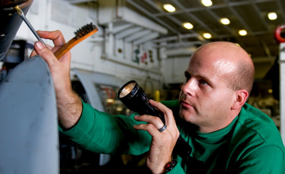 US Navy 110929-N-OK922-336 Aviation Structural Mechanic 1st Class Douglas Bogart, assigned to Helicopter Anti-Submarine Squadron (HS) 15, lubricat