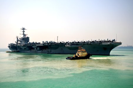 US Navy 110925-N-YM590-070 The Nimitz-class aircraft carrier USS John C. Stennis (CVN 74) departs Manama, Bahrain, after a scheduled port visit
