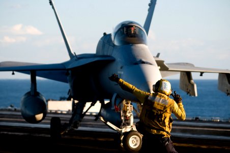 US Navy 110929-N-TZ605-258 Aviation Boatswain's Mate (Handling) 3rd Class Sean Pennala, assigned to Air Department's V-1 Division, directs an F-A-1