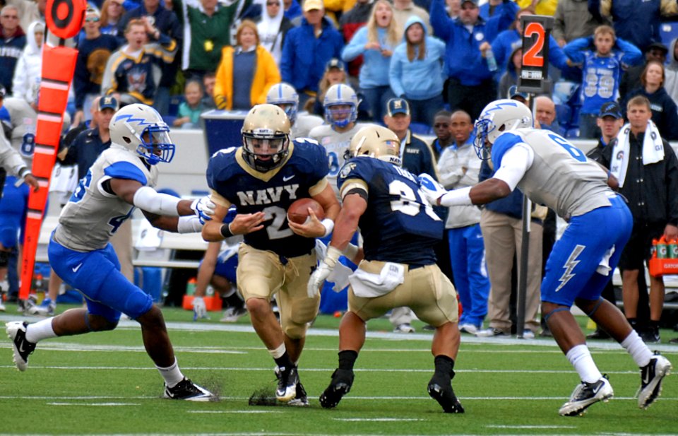 US Navy 111001-N-OA833-008 U.S. Naval Academy quarterback Kriss Proctor (^2) breaks a tackle and runs up the field during the fourth quarter of an