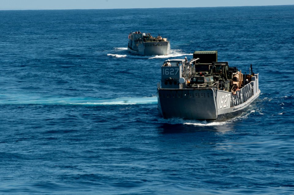 US Navy 110928-N-ER662-266 Landing Craft Utilities 1627 and 1631 prepare to enter the well deck of the forward-deployed amphibious assault ship USS