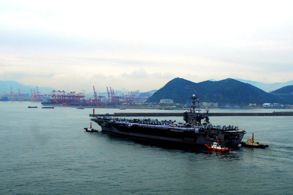US Navy 110929-N-DS193-023 Republic of Korea tug boats guide USS George Washington (CVN 73) into her moorings as the ship arrives for a port visit
