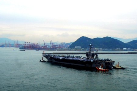 US Navy 110929-N-DS193-023 Republic of Korea tug boats guide USS George Washington (CVN 73) into her moorings as the ship arrives for a port visit