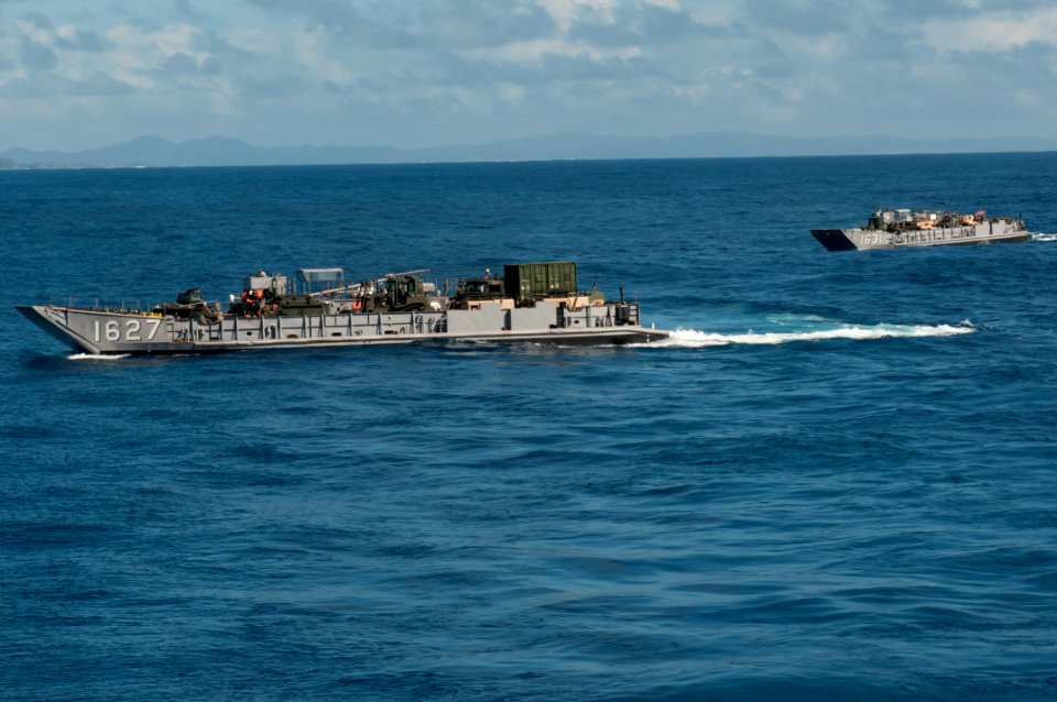 US Navy 110928-N-ER662-206 Landing Craft Utilities 1627 and 1631 prepare to enter the well deck of the forward-deployed amphibious assault ship US