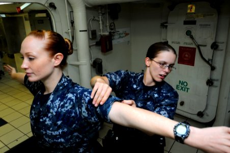 US Navy 110927-N-JD217-015 Electronics Technician 3rd Class Natasha L. Carlson, right, performs a search and seizure exercise with Aviation Ordnanc