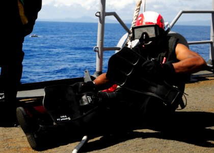 US Navy 110927-N-WJ771-049 Electronics Technician 3rd Class Jonathan A. Simmons prepares to enter the water during a man overboard drill aboard USS
