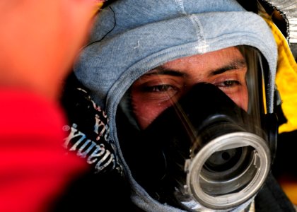US Navy 110927-N-WJ771-131 Aviation Boatswain's Mate (Handling) Airman Luis F. Campos removes his helmet after participating in crash and salvage e