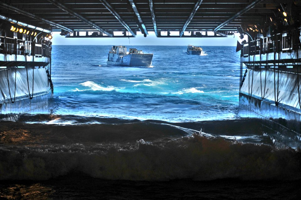 US Navy 110928-N-KM175-001 Landing Craft Utilities 1627 and 1631 prepare to enter the well deck of the forward deployed amphibious assault ship USS