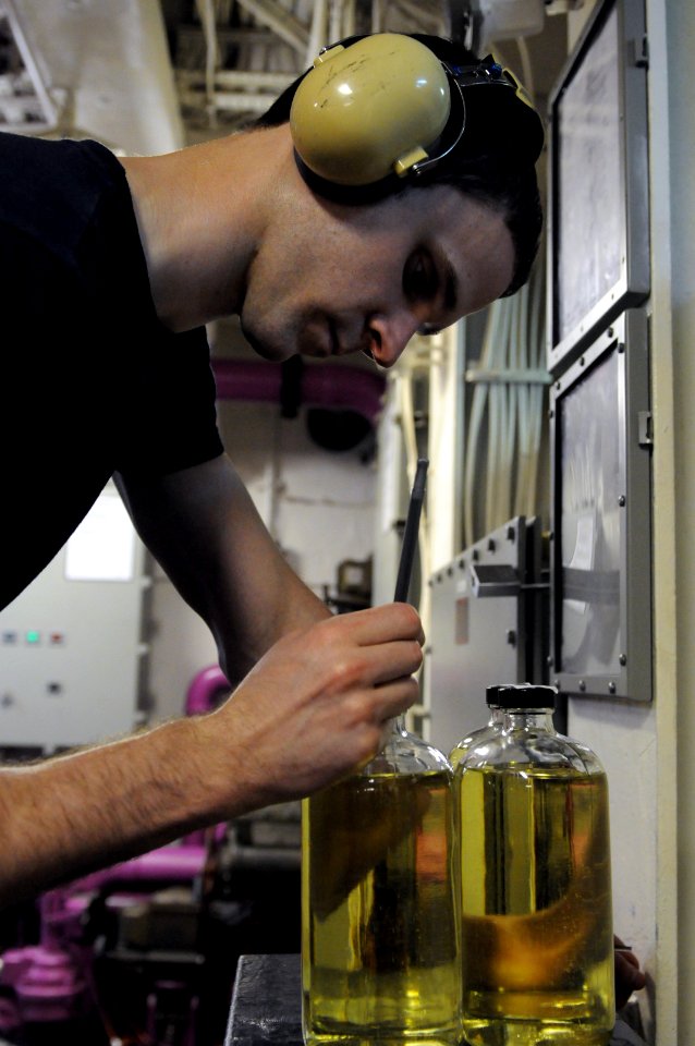 US Navy 110927-N-YC505-010 Aviation Boatswain's Mate (Fuel) 3rd Class Alan C. Smith records identifying information on a fuel sample in the aviatio