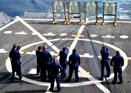 US Navy 110929-N-ZF681-256 Sailors fire 9 mm service pistol during small arms weapons qualifications aboard the guided-missile destroyer USS Halsey