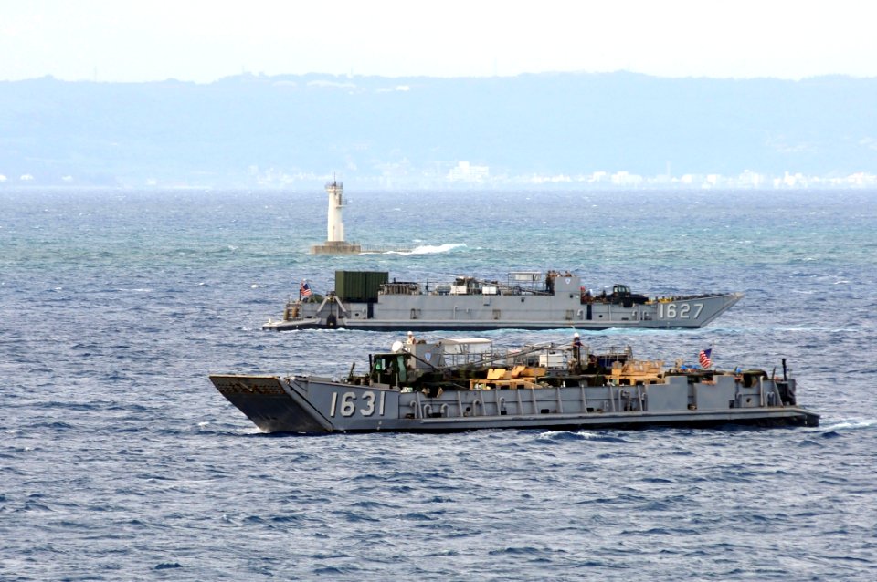 US Navy 111001-N-KM175-002 Landing Craft Utilities (LCU) 1631 and 1627, assigned to Beachmaster Unit (BMU) 1, prepare to enter the well deck of the