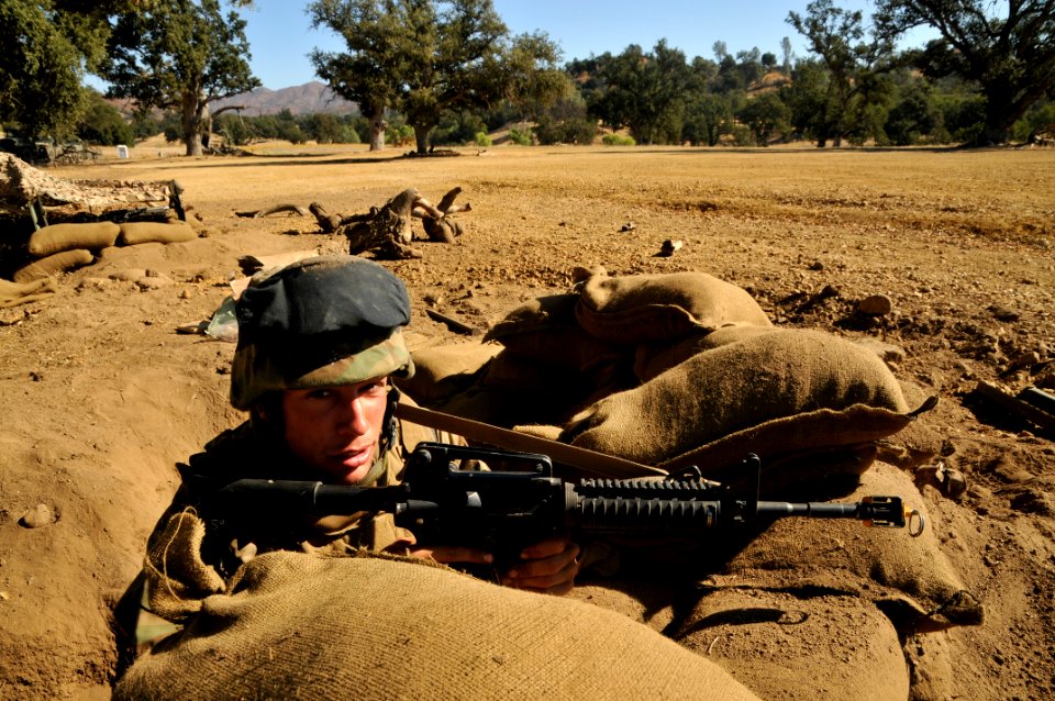 US Navy 111001-N-SM578-015 Equipment Operator Constructionman Timothy Chelson, assigned to Naval Mobile Construction Battalion (NMCB) 40, mans his