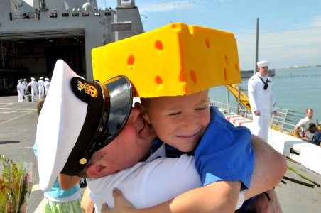 US Navy 110930-N-GW695-047 Command Master Chief Lee Bethel hugs his son after the amphibious transport dock ship USS Green Bay (LPD 20) returned to