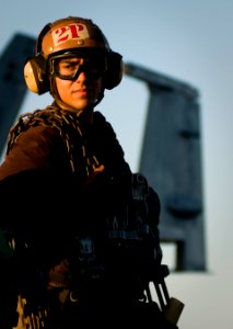 US Navy 110929-N-TZ605-329 Aviation Electrician's Mate Airman Avery Velarde, assigned to Strike Fighter Squadron (VFA) 81, waits to chain down airc