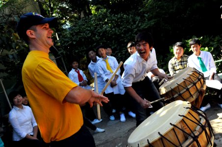 US Navy 111002-N-WW409-191 Aviation Ordnanceman 2nd Class Eric Glender, from Cincinnati, plays the drums with children during a community service e