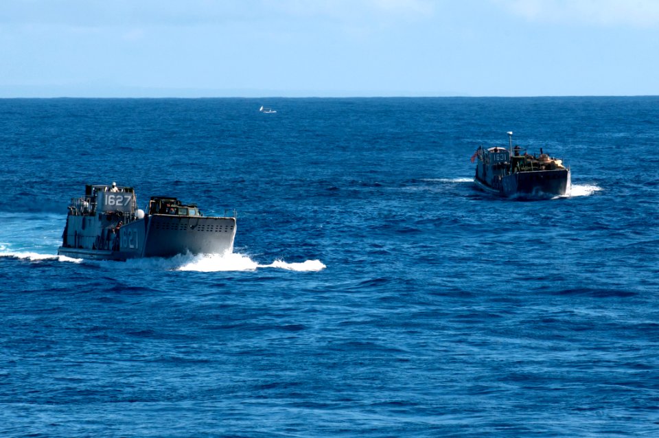US Navy 110928-N-ER662-210 Landing Craft Utilities 1627 and 1631 prepare to enter the well deck of the forward-deployed amphibious assault ship USS